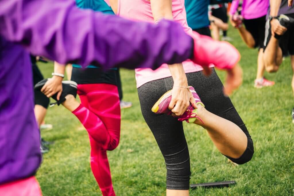 Group of people exercising on grass