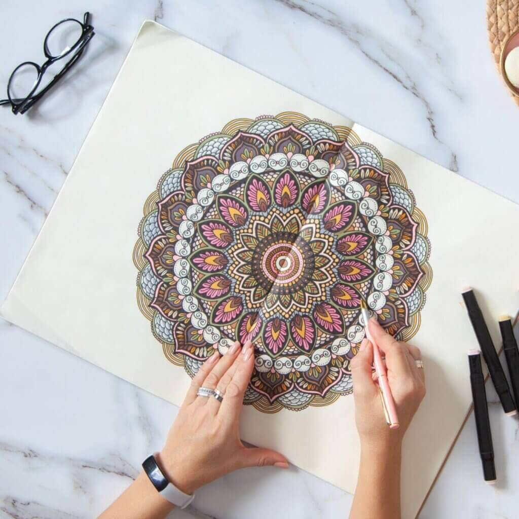Person coloring a Mandala, illustrating art therapy