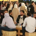 A group of people sitting at a table Description automatically generated with medium confidence